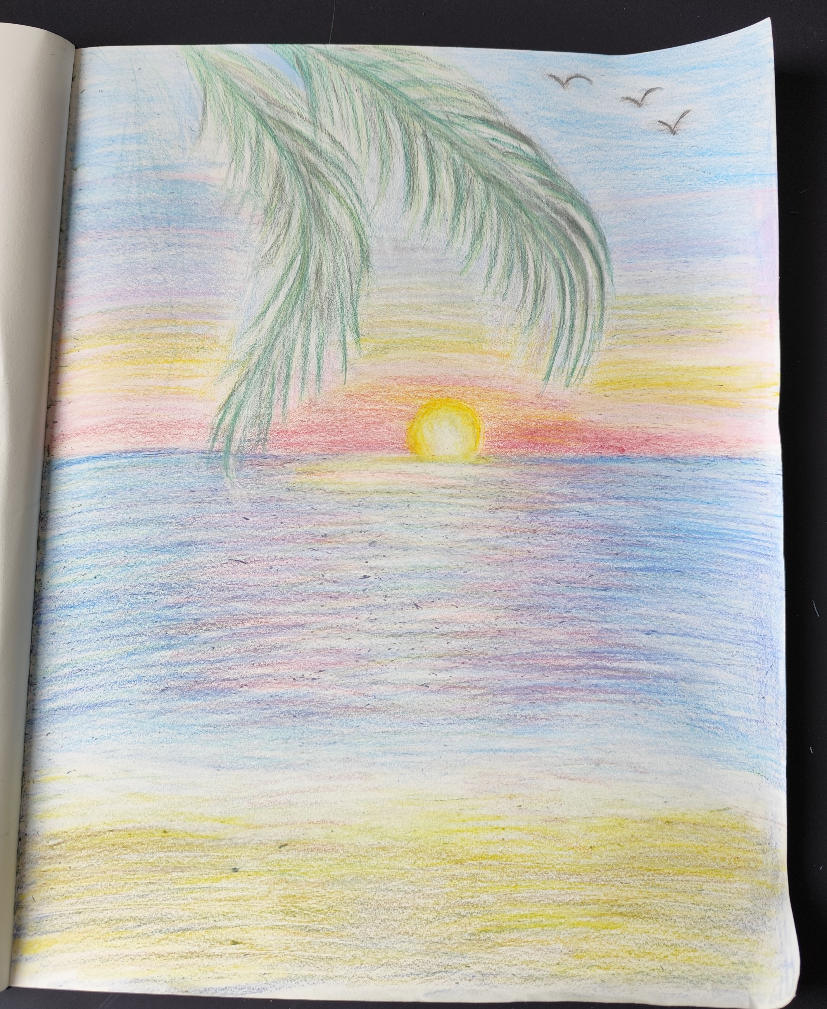 Colorful Sunset Over Calm Waves with Palm Frond