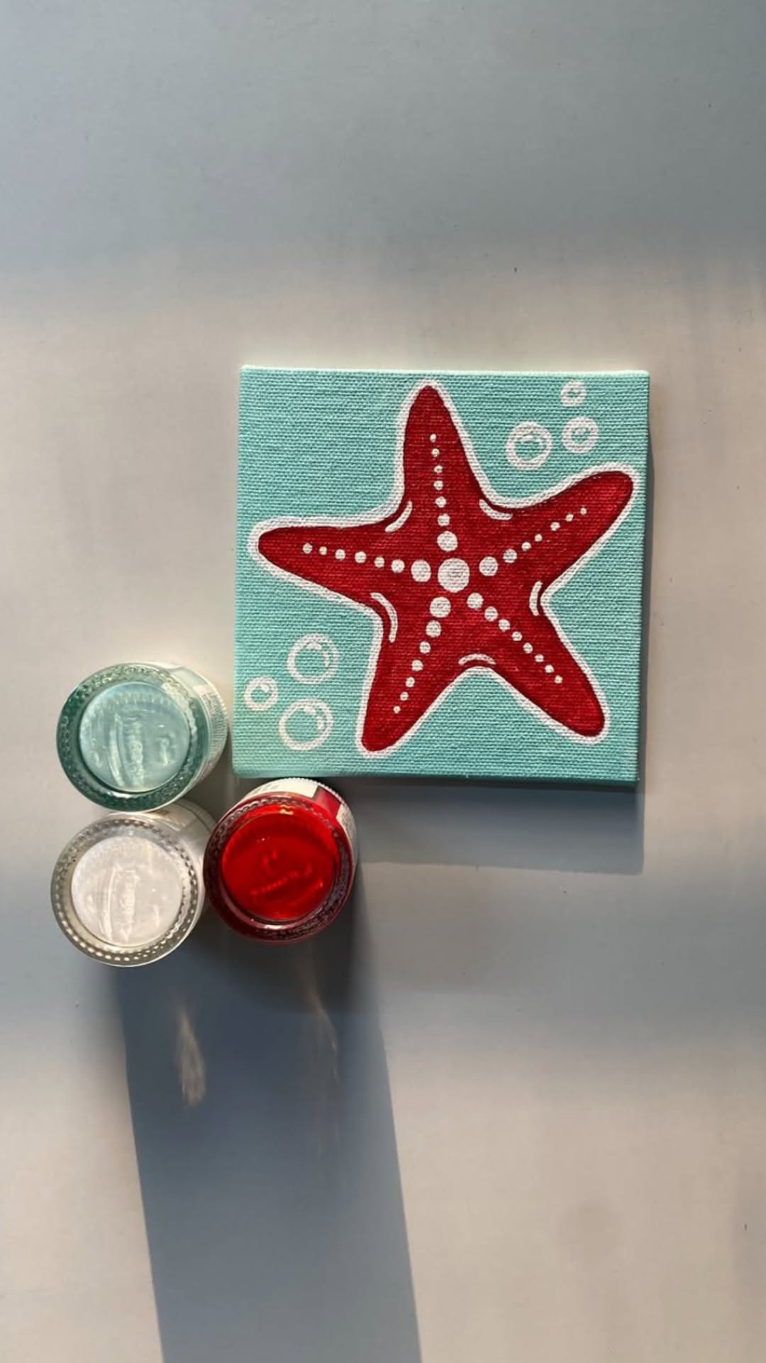 Adorable Red Starfish on Aquamarine Background