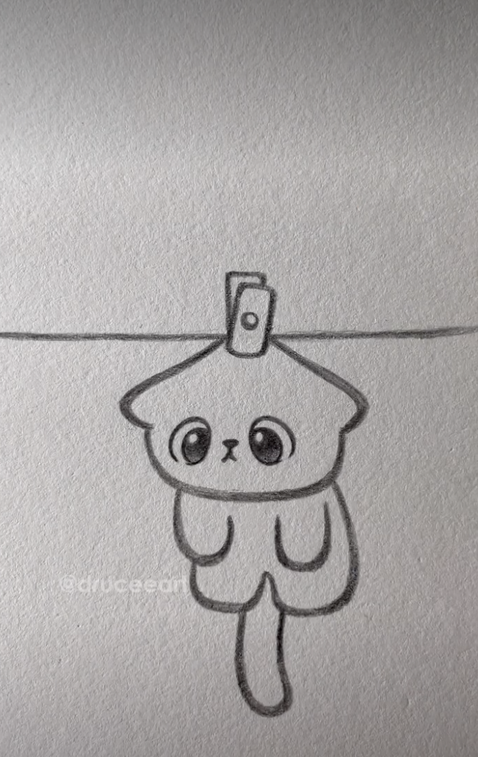 Adorable Kitten Hanging from a Clothesline